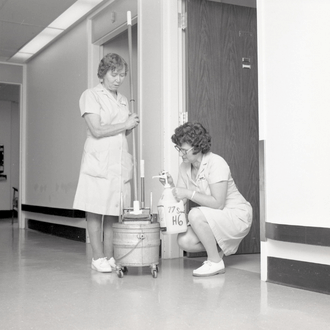 1977 - Two Housekeepers with mop and bucket